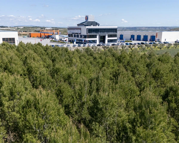 Vista de las oficinas centrales desde campo de pinos